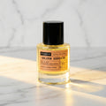 Alchemist Golden Goddess Extrait de Parfum bottle on a marble surface, inspired by YSL Libre