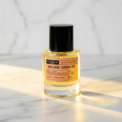 Alchemist Aromas Golden Goddess Extrait de Parfum bottle on a marble surface, inspired by YSL Libre